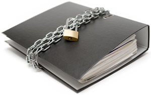 Documents in a black binder with a chain around the binder with a lock
