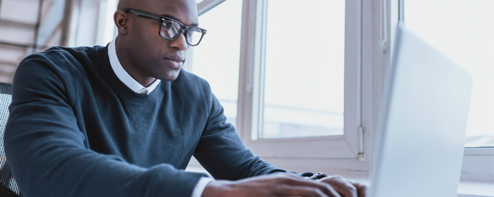 Man typing on a computer