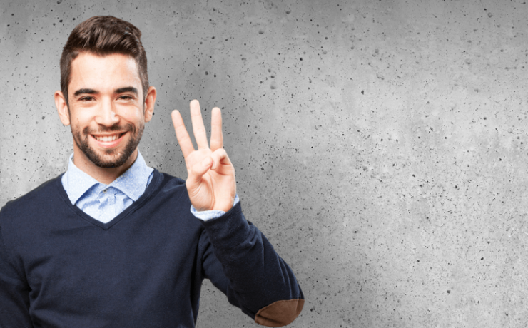 Young man smiling, holding up three fingers