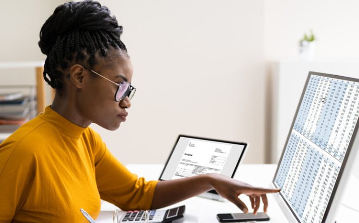 Young woman pointing at something on computer screen