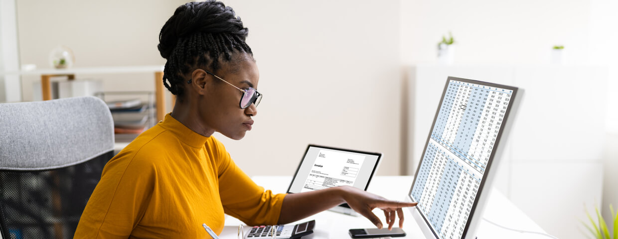 Young woman pointing at something on computer screen