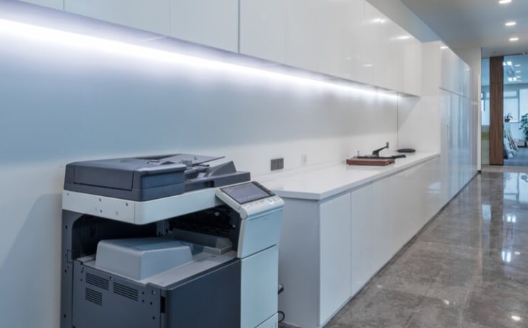 Brightly lit office hallway with a multifunction printer