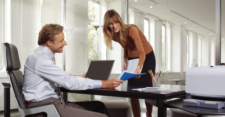 Two business people working together and smiling
