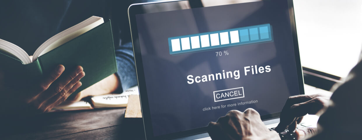 Close up of machine that has the words scanning files on the display with a progress bar