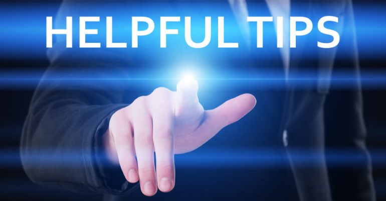 Man in suit placing finger on virtual display that reads helpful tips