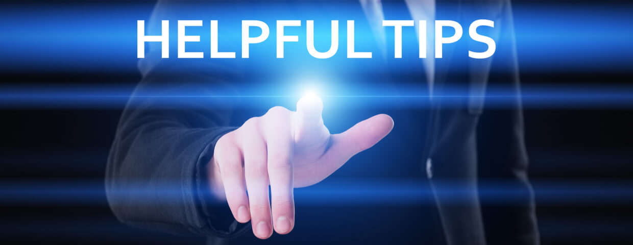 Man in suit placing finger on virtual display that reads helpful tips