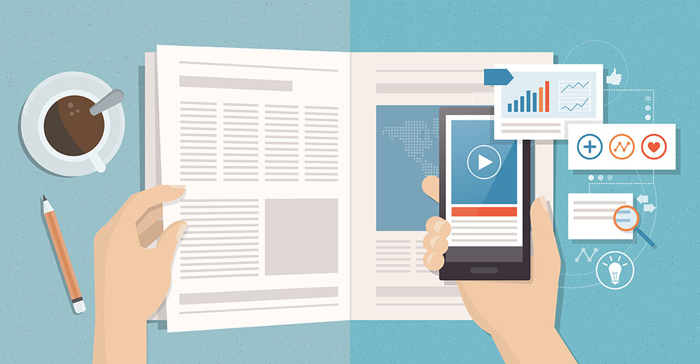Hand turning magazine pages with smart phone in other hand scanning what is on the page
